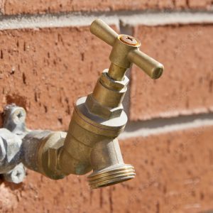 Outside tap on brick wall